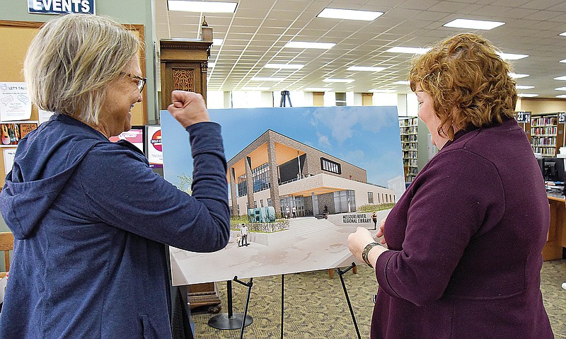 Julie Smith/News Tribune photo: 
Janice Orr, left, reacts with a "yes" as Claudia Young, director of Missouri River Regional Library, answers a question during Monday's morning opportunity to talk about the plans for expansion of the existing facility. Young greeted each of the visitors with a "good morning, Happy National Library Week," before explaining what the additional space will mean for patrons and staff.