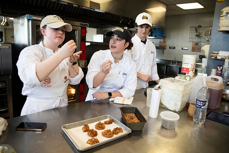 Students Natalie Mrak, Isabella Gigliotti, and Chris Buck work on a creating a baby food product using apples at the Drexel Food Lab in Philadelphia. (Monica Herndon/The Philadelphia Inquirer/TNS)