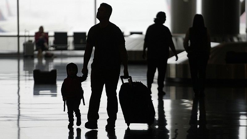 Travel credit card perks, like free checked bags, seat upgrades and access to airport lounges, can make a pregnant traveling more comfortable. 
(AP file photo/Rick Bowmer)
