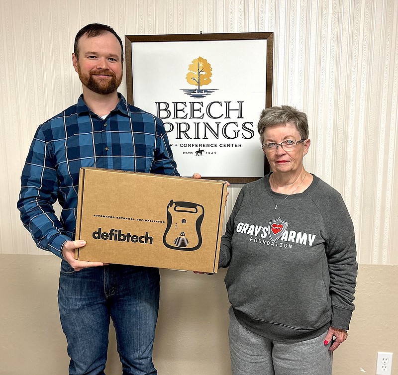 David Stanley, manager of Beech Springs Camp in Louann, accepts an automatic external defibrillator (AED) from Linda Kalcich, vice president Grayson's Army Foundation. GAF made the donation Monday as a part of an effort to make defibrillators available in area parks, ball fields, sports facilities and other such locations in Union County. The nonprofit organization has also raised money to purchase three AEDs for the El Dorado-Union County Recreation Complex and expects to install the devices within the next couple of weeks. (Contributed)