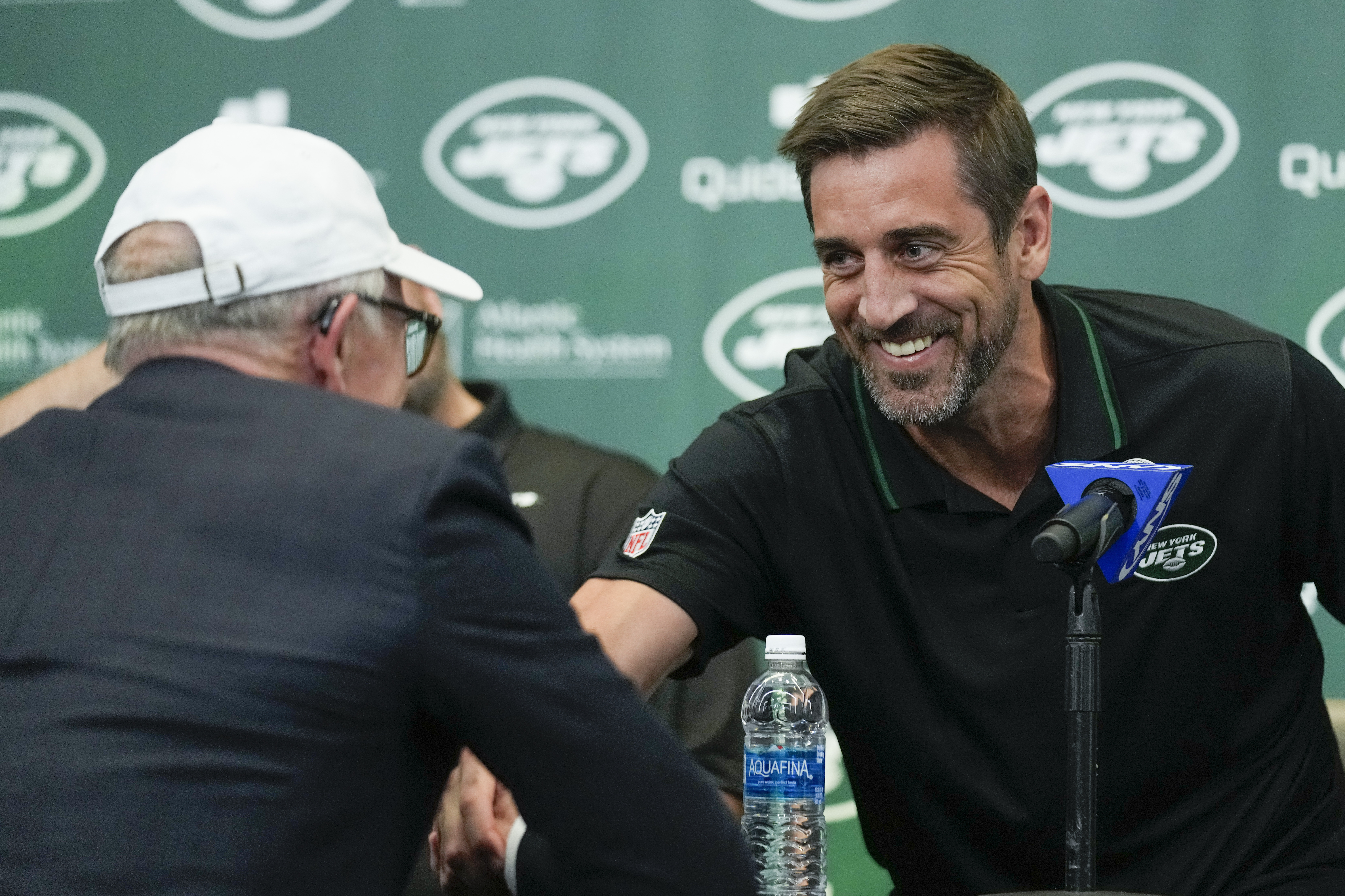 New York Jets' quarterback Aaron Rodgers, third from right, poses for a  picture with general manger Joe Douglas, left, president Hymie Elhai,  second from left, co-owner Christopher Johnson, third from left, owner
