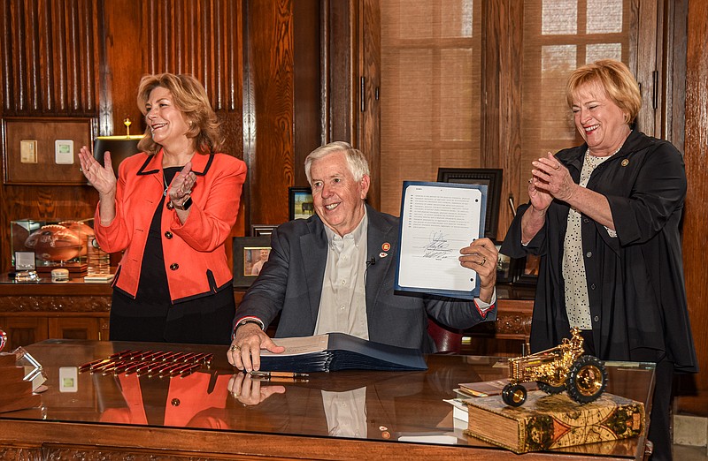 Julie Smith/News Tribune
Flanked by Rep. Brenda Shields, R-St. Joseph, at left, and Sen. Karla Eslinger, R-Wasola, Gov. Mike Parson signs SB 51 which allows individuals to seek out a physical therapist without a doctor's reccommendation. Parson commented that the bill has been around a long time and that he handled it when he was a senator.