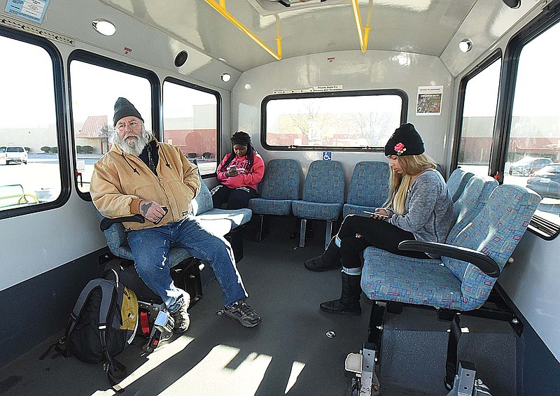Ozark Regional Transit passengers wait Nov. 22, 2017, for a bus to depart from a stop in Rogers.
(File Photo/NWA Democrat-Gazette/Flip Putthoff)