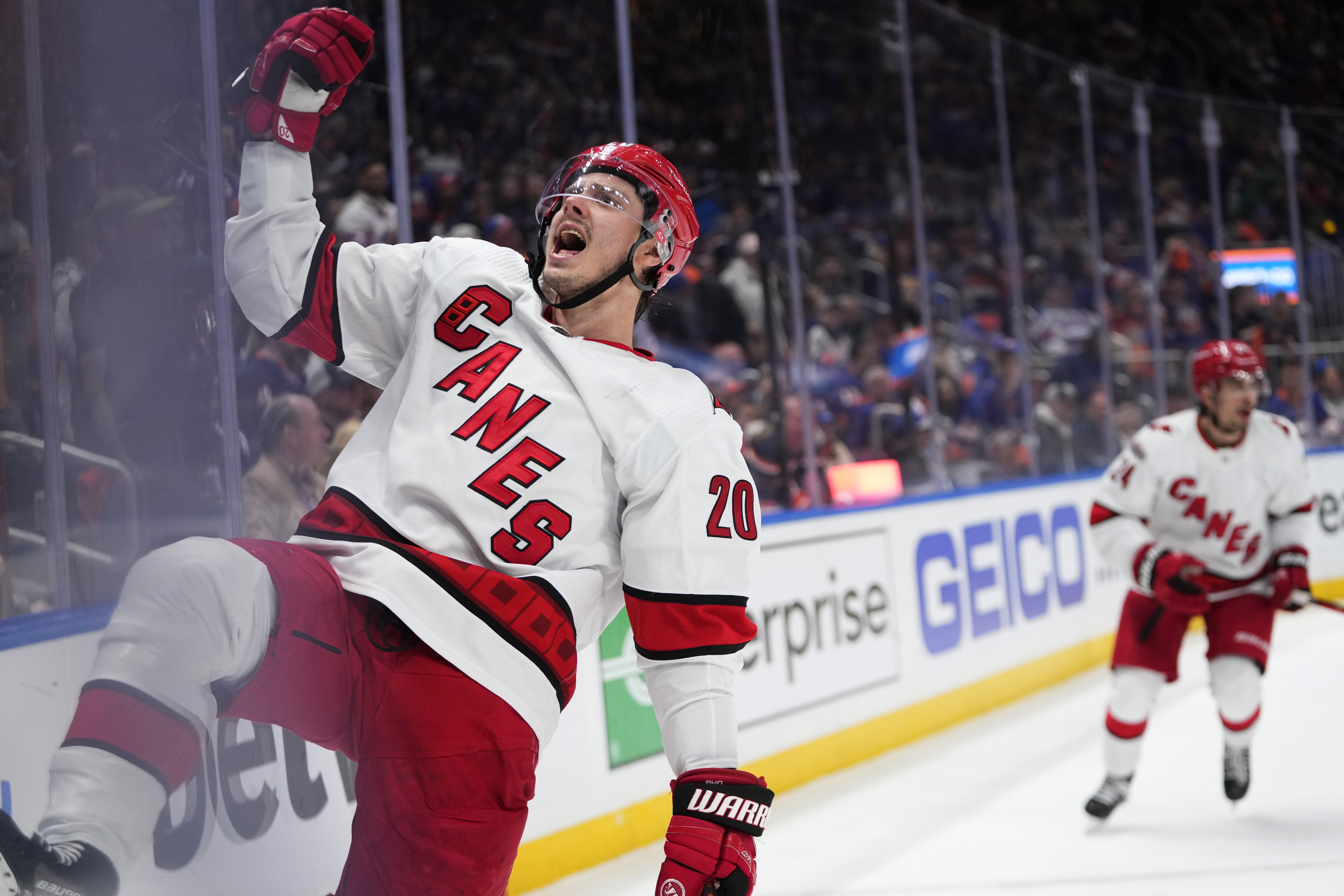 Carolina Hurricanes' Jordan Staal (11) celebrates his empty net goal during  the third period of an NHL hockey game against the Boston Bruins with  teammates Jordan Martinook, center, and Carolina Hurricanes' Brady