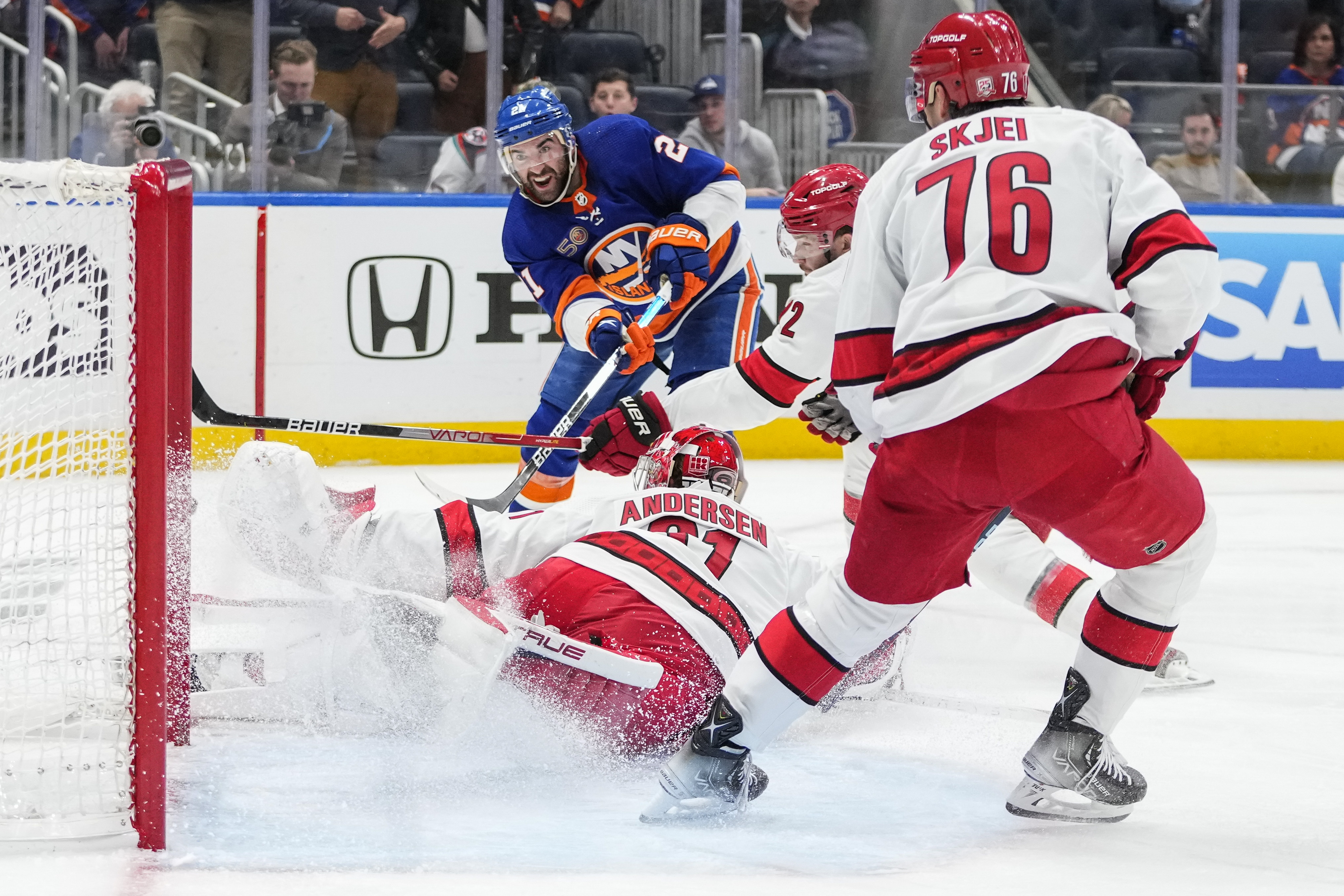 Carolina Hurricanes' Jordan Staal (11) celebrates his empty net goal during  the third period of an NHL hockey game against the Boston Bruins with  teammates Jordan Martinook, center, and Carolina Hurricanes' Brady