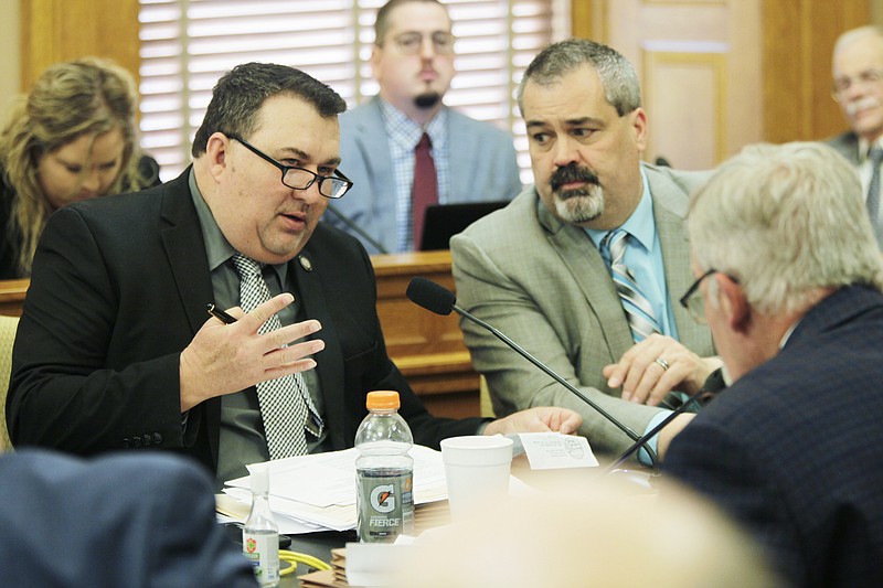 Kansas state Sen. Rob Olson, left, R-Olathe, speaks during negotiations between the House and Senate on legislation, Friday, April 28, 2023, at the Statehouse in Topeka, Kan. No big tax cuts are coming for Kansas residents even though the state treasury is bulging with surplus cash. (AP Photo/John Hanna)