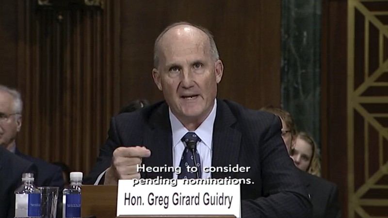 In this image from video provided by the U.S. Senate, Judge Greg Guidry speaks during a hearing for district court nominees held by the Senate Committee on the Judiciary in Washington, on Wednesday, Feb. 13, 2019. Guidry donated tens of thousands of dollars to New Orleans Roman Catholic archdiocese and consistently ruled in favor of the church amid a contentious bankruptcy involving nearly 500 clergy sex abuse victims, The Associated Press found, an apparent conflict that could throw the case into disarray.(U.S. Senate via AP)
