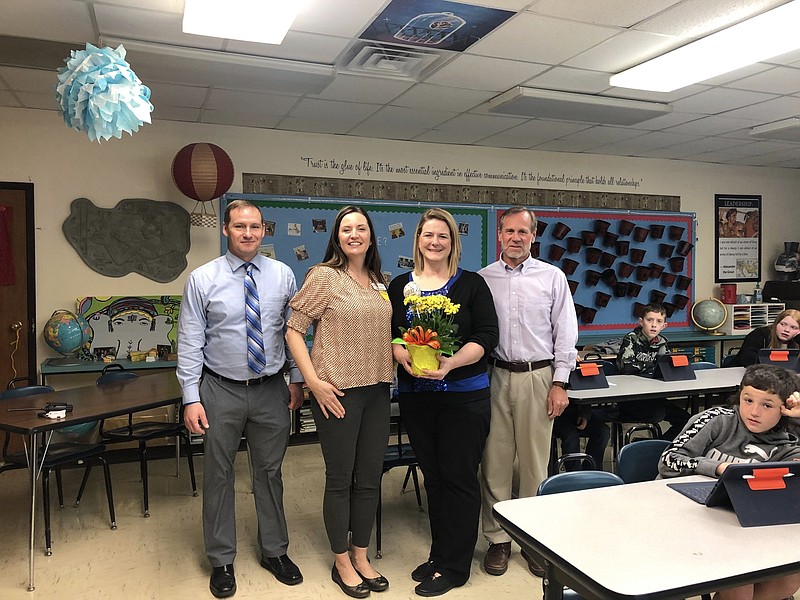 Photo courtesy South Callaway R-II School District: 
South Callaway Middle School social studies and instructional coach Danielle Hecktor holds a bouquet of flowers after learning she would be recognized as the 2023 Middle School Educator of the Year by the Northeast Region of MSTA. Left to right: superintendent Corey Pontius, MSTA representative Sarah Papineau, Hecktor and principal Gary Bonsall.