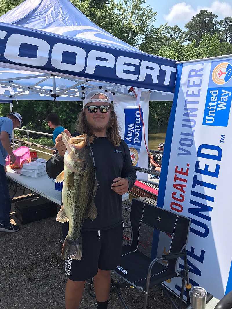 Drew Raffaelli showcases his bass during last year's weigh in at the Cooper Tire Big Bass Fishing Tournament. (Submitted photo)