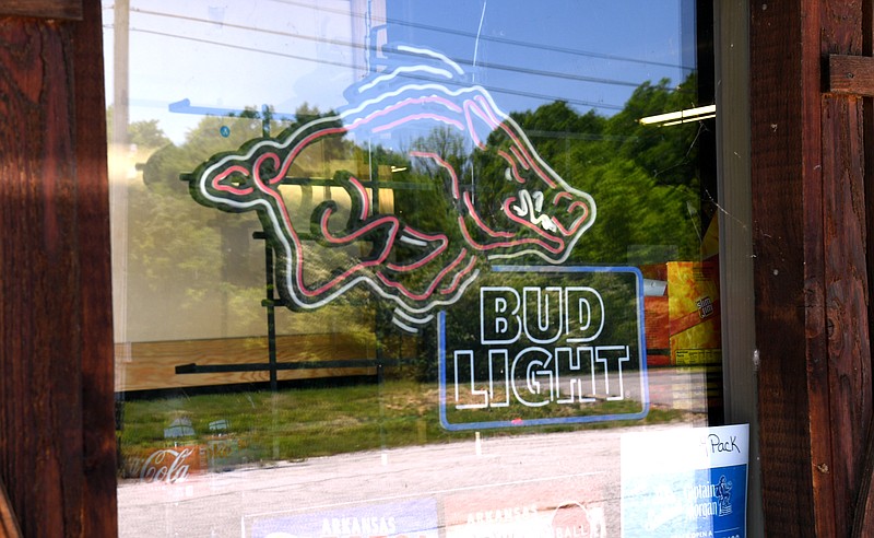 This Bud Light sign seen in the window at Bud's Liquor, 4761 Malvern Ave., stopped working prior to the controversy. - Photo by Lance Brownfield of The Sentinel-Record