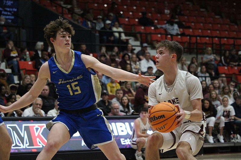 Lake Hamilton's Zac Pennington prepares to shoot while Harrison's Ryder Scribner (15) defends March 4 in the Class 5A state semifinals at Pine Bluff Convention Center. - Photo by Krishnan Collins of The Sentinel-Record