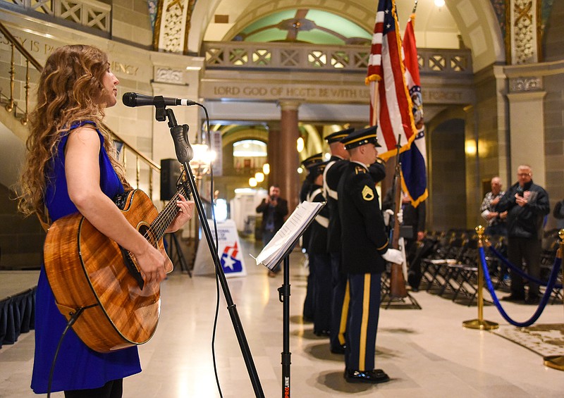 Julie Smith/News Tribune
As members of the Missouri National Guard  Color Guard post the colors, Camille Harris delivers the Star Spangled Banner with a touch of acoustic guitar at the opening of Thursday's National Day of Prayer event in the Capitol Rotunda. A small but prayerful crowd gathered for the annual service which did draw people from across the area to hear speakers talk about the importance of marriage, a special recognition of Don Hinkle who was an organizer and participant in many previous prayer events who passed away in September of 2022.