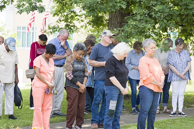 Photo by Tina Sams
Ouachita County residents bow their heads in prayer at the Oauchtia County Courthouse during the May 4 National Day of Prayer.