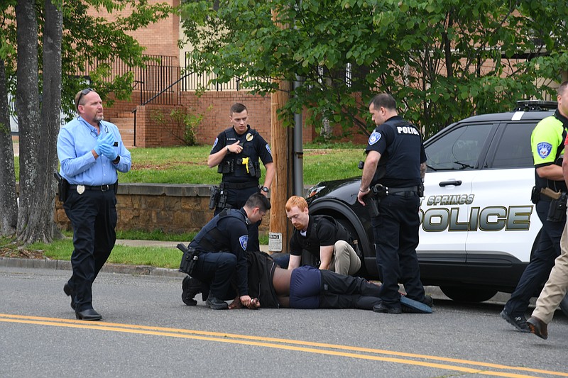 Hot Springs police take a Pine Bluff man into custody Friday near the corner of Orange Street and Quapaw Avenue after he allegedly robbed the Bank OZK, 333 Ouachita Ave. - Photo by Lance Brownfield of The Sentinel-Record.