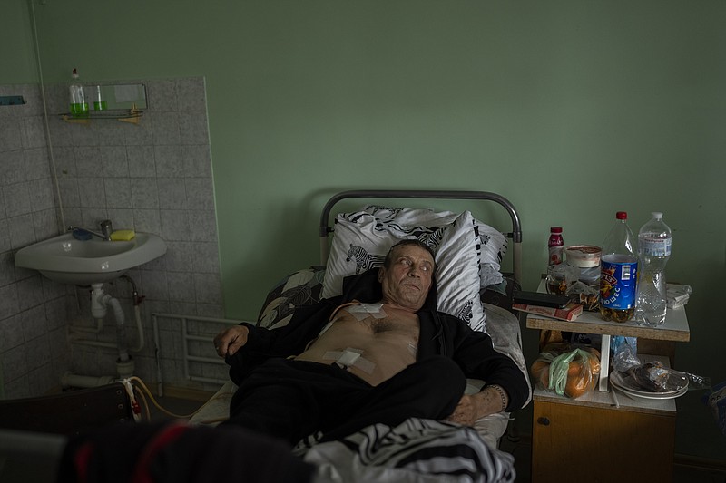 Ukrainian farmer Mykola Ozarianskyi lays in a hospital bed in Kryvyi Rih region, eastern Ukraine, Monday, April 24, 2023. Bankruptcy is looming for many Ukrainian farmers across the war-torn country who are struggling to seed crops amid widespread mine contamination in areas once occupied by Russian forces and rising costs associated with exports. (AP Photo/Bernat Armangue)