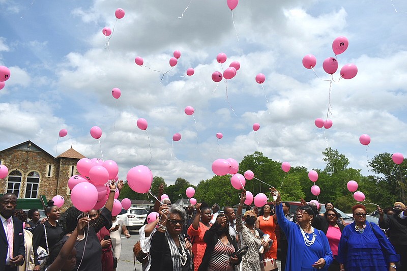 Balloons are released Sunday in honor of Cleashindra "Clea" Hall, who has been missing since May 9, 1994, outside St. Peter's Rock Missionary Baptist Church in Pine Bluff. (Pine Bluff Commercial/I.C. Murrell)