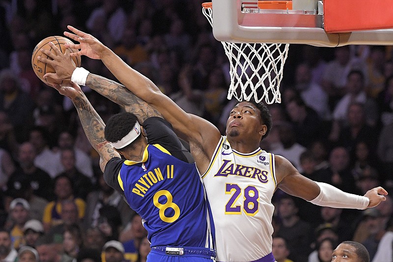 Golden State Warriors guard Gary Payton II, left, shoots as Los Angeles Lakers forward Rui Hachimura defends during the second half in Game 3 of an NBA basketball Western Conference semifinal Saturday, May 6, 2023, in Los Angeles. (AP Photo/Mark J. Terrill)