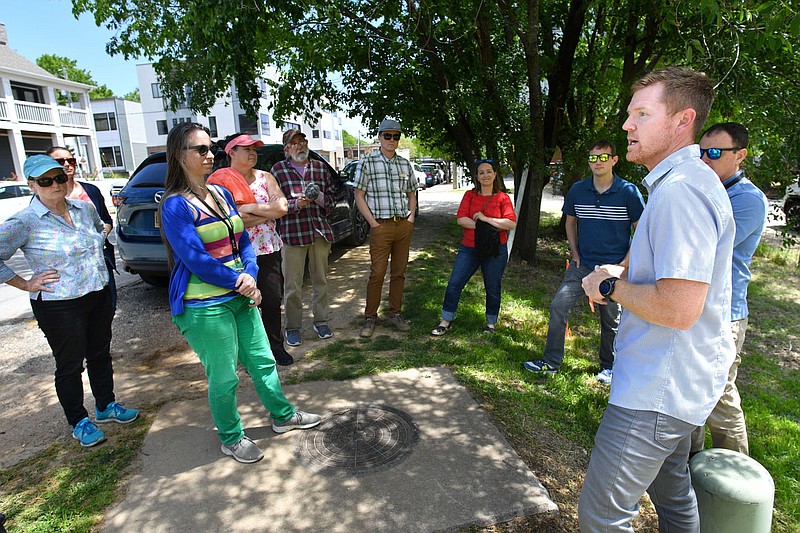 Jared Draper (right) with Toole Design Group leads a discussion Wednesday, May 3, 2023, with a large group of city staff and stakeholders during a tour of infrastructure around Martin Luther King Jr. Boulevard and School Avenue in south Fayetteville. Toole Design Group is assisting the Northwest Arkansas Regional Vision Zero Plan with its strategy to prevent traffic deaths through the implementation of infrastructure changes following a study of the area. Visit nwaonline.com/photo for today's photo gallery. 
(NWA Democrat-Gazette/Andy Shupe)