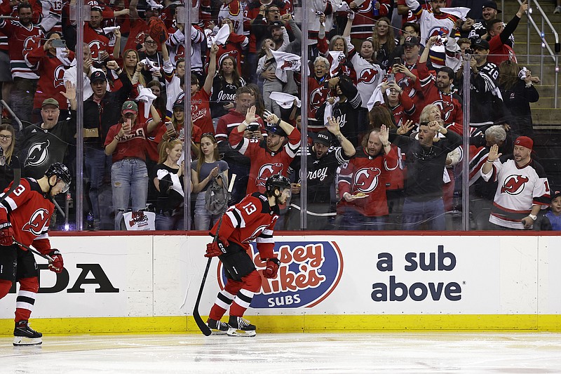 A New Jersey Devils fan celebrates the team's first goal against