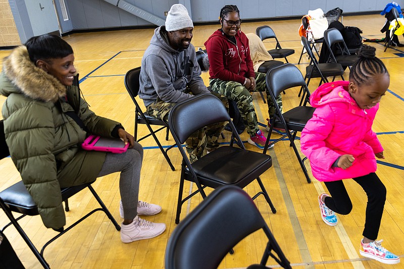 Danielle Champ, Ron Brown and their older daughter, Zyah, watch Morghan Jones, Zyah's 6-year-old sister, dance at the Deanwood Recreation Center's annual Black history program in D.C. on Feb. 25. MUST CREDIT: Photo for The Washington Post by Julia Nikhinson