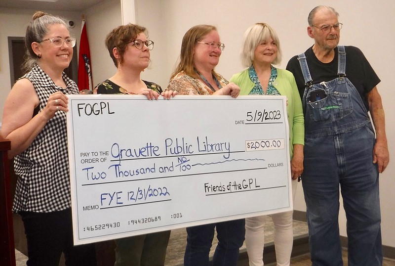 Friends of Gravette Library present 2,000 donation check Westside