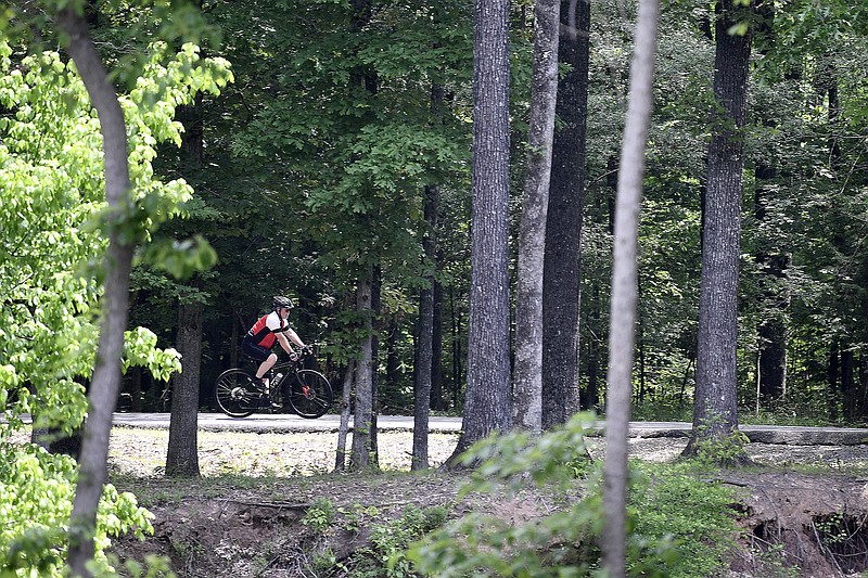 A cyclist rides along the Arkansas river trail through Burns park on Monday, May 8, 2023.

(Arkansas Democrat-Gazette/Stephen Swofford)