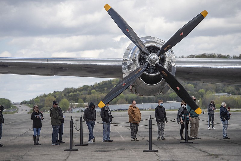 People wait in line Sunday April 18, 2021 to tour a Boeing B-29 Superfortress at the Arkansas Air & Military Museum at Drake Field in Fayetteville. The plane was built in 1944 and was part of the Snow White and the Seven Dwarves Squadron with the designation of Doc. The plane is one of only two B-29 Superfortresses still flying. For more information about Doc, see www.b29doc.com Visit nwaonline.com/2100419Daily/ and nwadg.com/photo. (NWA Democrat-Gazette/J.T. Wampler)