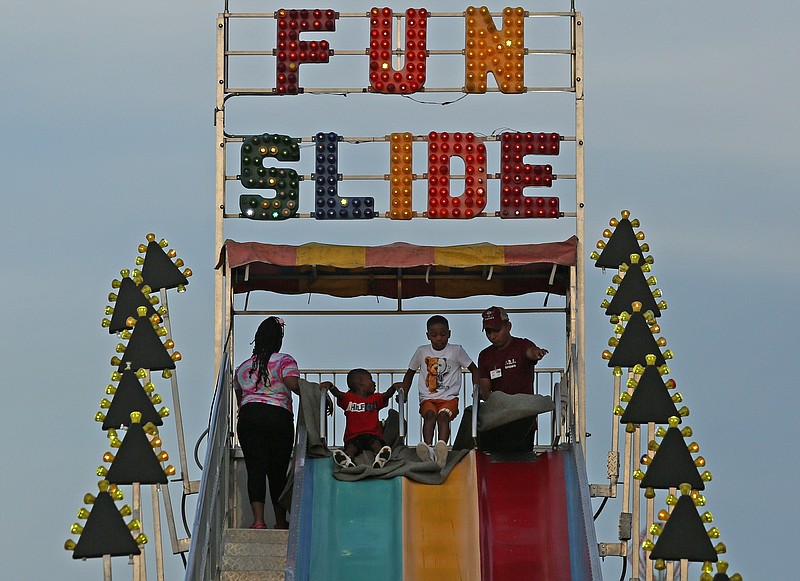 Young people prepare to ride down a slide during the Pulaski County Fair in North Little Rock's Riverfront Park in May 2022.

(Democrat-Gazette file photo/Colin Murphey)