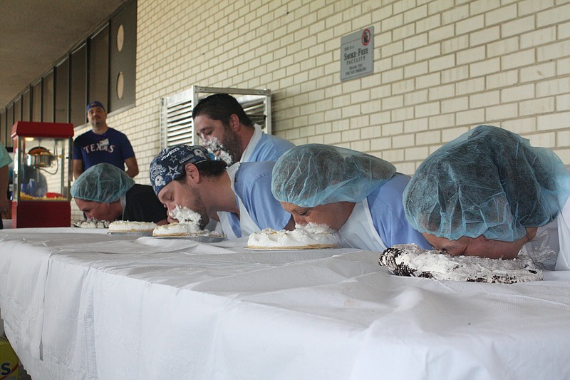 Nurses, Doctors and hospital staff watch as colleagues participate in a pie eating contest Wednesday, May 10, 2023 at Wadley Regional Medical Center. Participants were, from left, Dr. Stacy Leonard, Mat Sepcic, Dr. Rodney LaGrone, Michelle Hopkins and Dr. Cherry Fu. Fu ended up winning the contest by eating the most pie in a minute, while the rest of her competitors were creamed. (Staff photo by Mallory Wyatt)