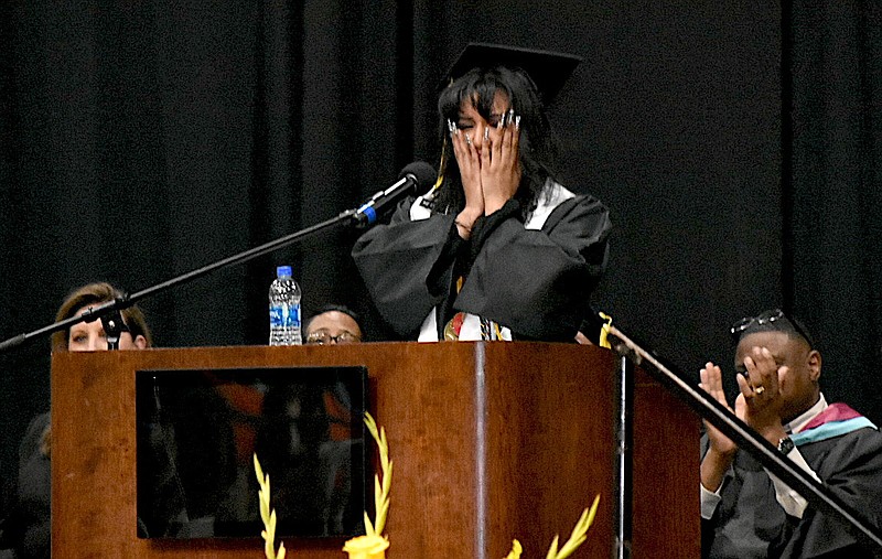 April Hernandez pauses in emotion as she gives the salutatory address Tuesday night in Watson Chapel High School's graduation at the Pine Bluff Convention Center. Applauding Hernandez in the background from left are Watson Chapel School District assistant superintendent LaDonna Spain, school improvement specialist Kerri McNeal and Principal Henry Webb. See a photo gallery from graduation night in this section. (Pine Bluff Commercial/I.C. Murrell)