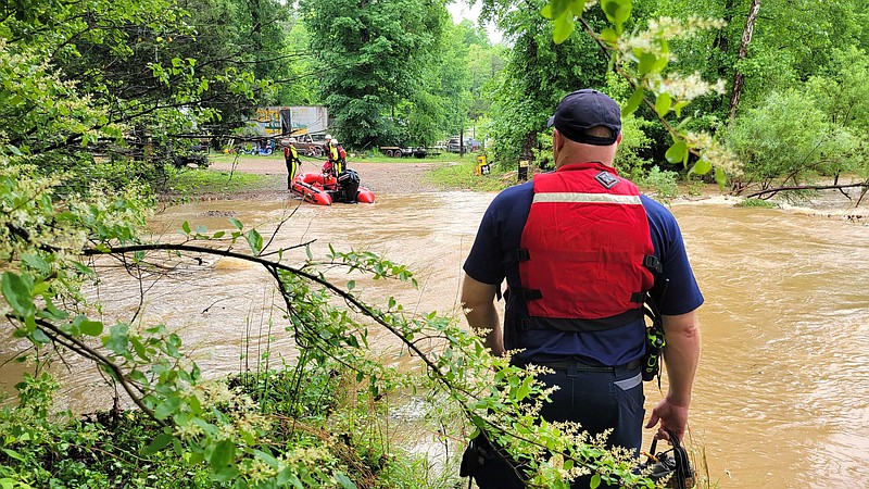 The Hot Springs Fire Department's swift water rescue team deploys at Bryant Place, where the swollen South Fork of the Saline River had trapped people in their homes. - Photo by Lance Brownfield of The Sentinel-Record