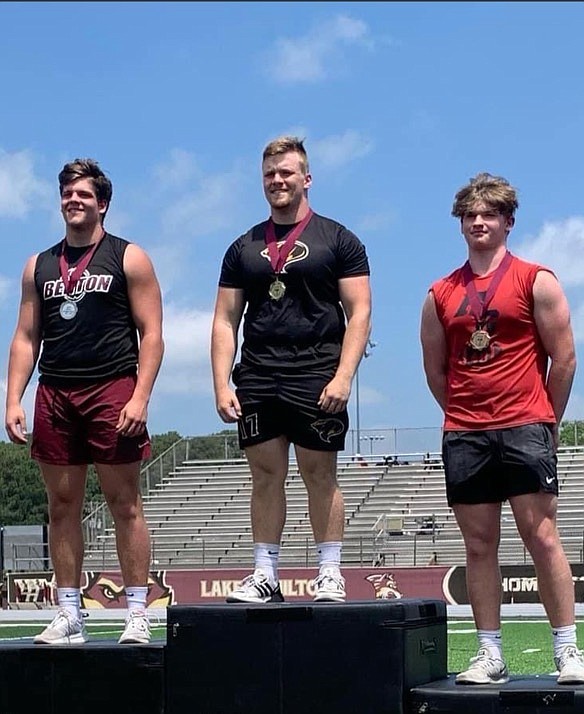 From left, Peyton McNeeley, of Benton, junior Abram Davis, of Fountain Lake, and Mattox Moore, of Haskell-Harmony Grove, are shown at the state weightlifting meet on Lake Hamiltons football field May 6. Davis won the State Championship for the 242 weight class. - Submitted photo