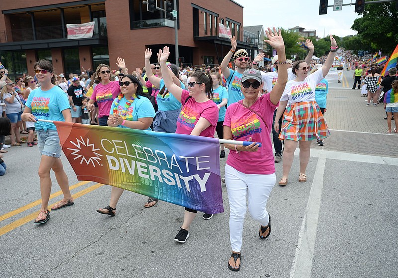 Representatives from the Walton Arts Center make their way down Dickson Street on June 26, 2021, during the 17th annual Northwest Arkansas Pride Festival and Parade in Fayetteville. Members say the Walton Arts Center board never voted on a decision to prohibit any drag performances in which minors would be allowed to attend at the center during this year's event.
(File photo/NWA Democrat-Gazette/Andy Shupe)