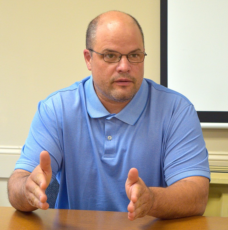 Ron Luckow, humanities instructor at the Arkansas School for Mathematics, Sciences, and the Arts, talks about the school's stock market team's success this year, while on campus Thursday. - Photo by Donald Cross of The Sentinel-Record