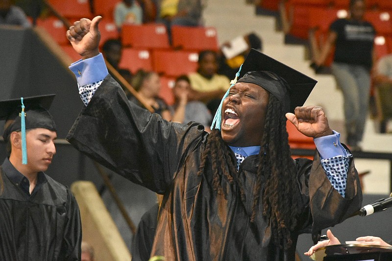 Herbert Williams III lets out a yell as he receives his associate's degree in technical career programs during Southeast Arkansas College's graduation Friday at the Pine Bluff Convention Center. (Pine Bluff Commercial/I.C. Murrell)
