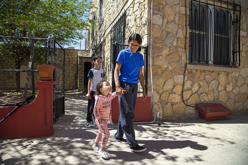 Venezuelan migrant Juaniela Castillo walks around St. Francis Xavier Church with two of her children Victoria, 3, and Carmelo, 8, in El Paso, Texas, Thursday, May 11, 2023. As confusion explodes in El Paso, one of the busiest illegal crossings points for migrants seeking to flee poverty and political strife, faith leaders continue to provide shelter, legal advice and prayer. (AP Photo/Andres Leighton)