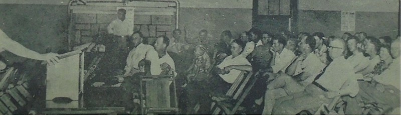 The public meeting at the Community Building on June 21, 1951. In the back center, Bob Henry raises his hand--the first to pledge funds to help bring Pluss Poultry to Siloam Springs.