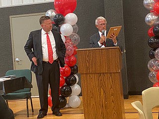 Retired Circuit Judge Gary Arnold (right) presents Benton County Circuit Judge Tom Smith a plaque in recognition of his 10 years of presiding over the countys drug court. The presentation was at Fridays Benton County Specialty Courts Graduatio n Ceremony. 
(NWA Democrat-Gazette/Tracy M. Neal)