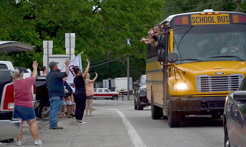 Annette Beard/Pea Ridge TIMES
The Lady Blackhawk softball team was cheered on their way out of town going to the state tournament semi-finals as they drove by each school campus.