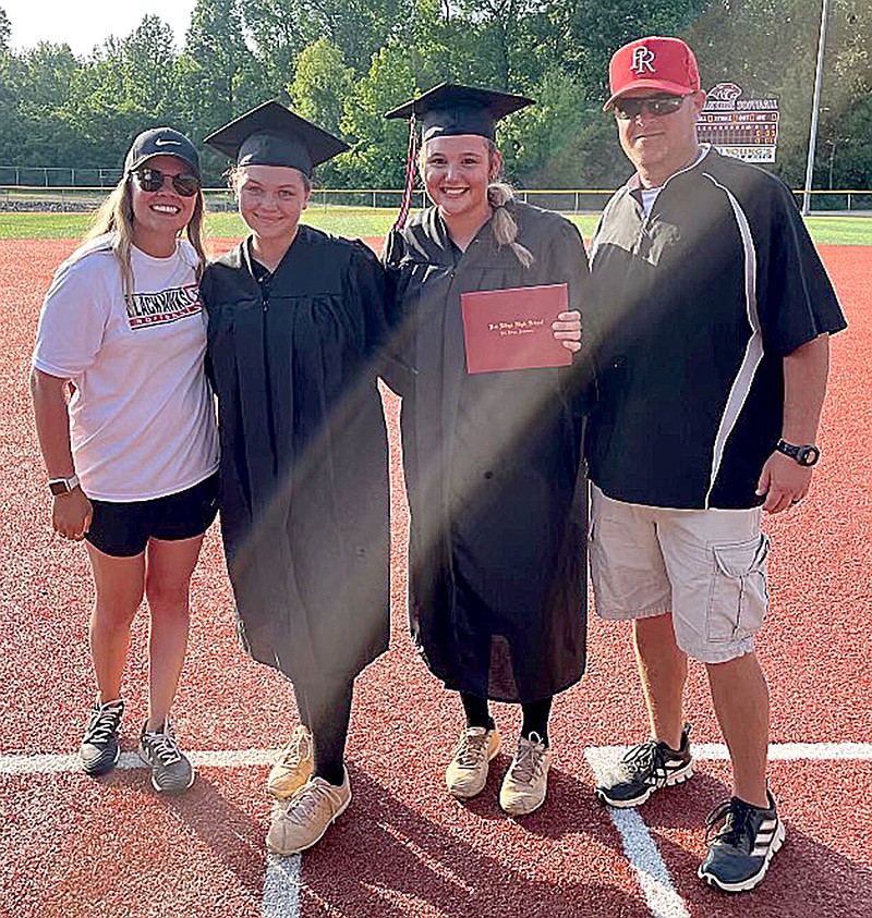 Courtesy photograph
Ashley Earley and Gracie McGarrah, two of the three seniors of the Lady Blackhawks softball team, received their diplomas while on the softball field in Cabot just before the quarter-final game against Malvern. PRHS graduation was at 2 p.m. Saturday.