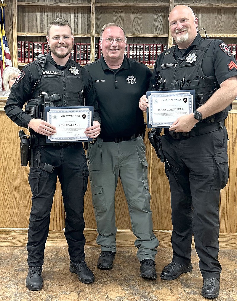 Annette Beard/Pea Ridge TIMES
Pea Ridge Police Chief Lynn Hahn, center, commended Pea Ridge Police Officer Levi Wallace, left, and Sgt. Todd Cornwell, right, during the May 16 City Council meeting for saving a man's life using Narcan in March.