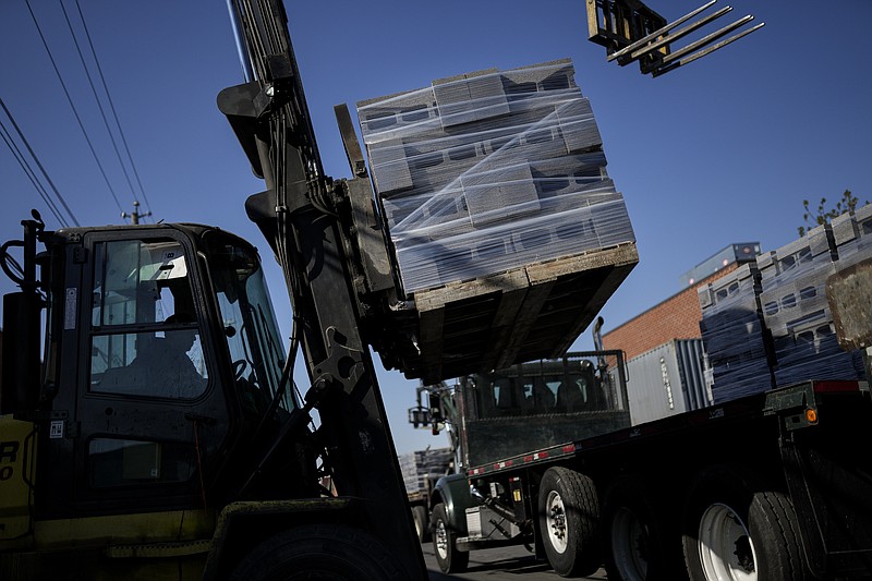 A forklift operates a load of concrete blocks, made with liquid carbon dioxide as an ingredient, onto trucks at the Glenwood Mason Supply Company, Tuesday, April 18, 2023, in the Brooklyn borough of New York. New York is forcing buildings to clean up, and several are experimenting with capturing carbon dioxide, cooling it into a liquid and mixing it into concrete where it turns into a mineral. (AP Photo/John Minchillo)