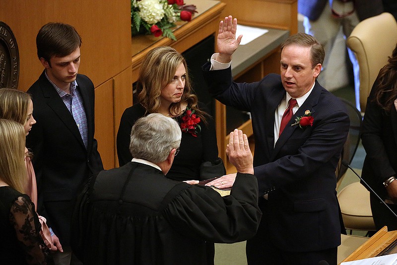 Rep. Matthew Shepherd (center), R-El Dorado, is sworn in as Speaker of the House by his father, Judge Bobby Shepherd, of the United States Court of Appeals for the Eighth Circuit, during the first day of the Arkansas General Assembly session on Monday, Jan. 9, 2022, at the state Capitol in Little Rock. 
More photos at www.arkansasonline.com/110lege/
(Arkansas Democrat-Gazette/Thomas Metthe)