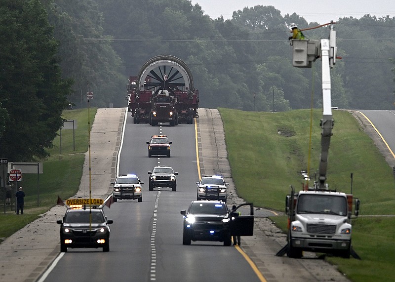 Officials escort a 600,000 pound kiln from El Dorado to Stephens on the third day of the kilns six day journey from Crossett to Gum Springs on Friday, May 12, 2023. More photos at arkansasonline.com/513kiln/

(Arkansas Democrat-Gazette/Stephen Swofford)
