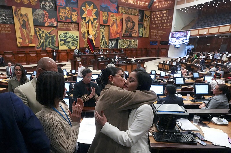 Colleagues congratulate opposition lawmaker Viviana Veloz, right, after she addressed the National Assembly during an impeachment hearing by lawmakers seeking to try President Guillermo Lasso for embezzlement in Quito, Ecuador, Tuesday, May 16, 2023. (AP Photo/Dolores Ochoa)