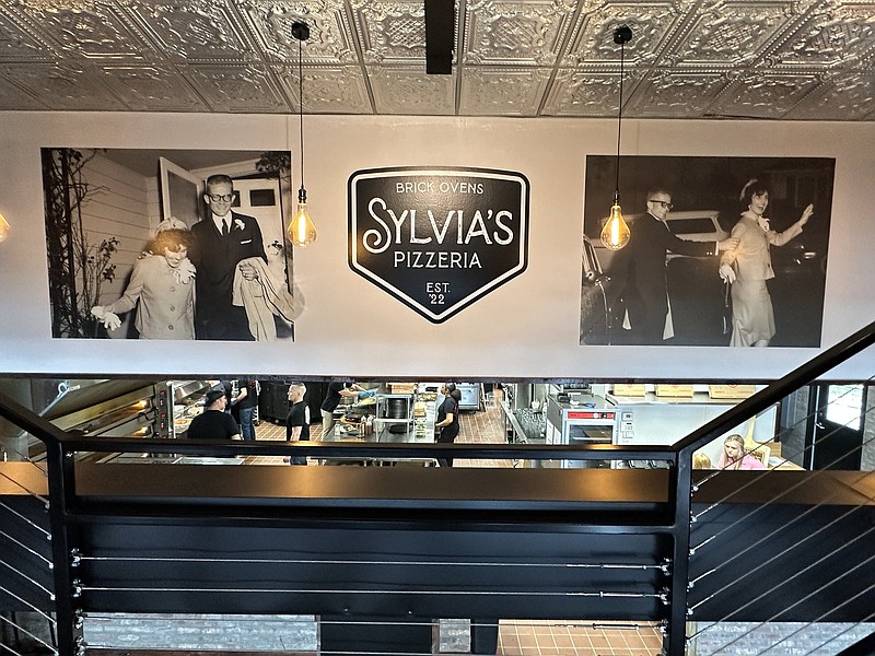 The interior of Sylvia's Pizzeria is a mashup of modern and metal, and the large mural visual from the stairs leading to the second floor is a nod to owner John Smykla's parents, Peter and Sylvia Smykla. The restaurant is named for his late mother. (Special to The Commercial/Deborah Horn)