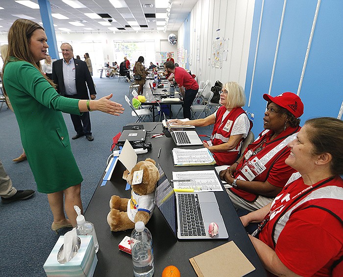 Gov. Sarah Huckabee Sanders talks with Red Cross volunteers Carolyn Harrel (from left), Brenda Canada and Jacki Breininger while touring the Red Cross headquarters on Tuesday, May 16, 2023, in Little Rock. 
(Arkansas Democrat-Gazette/Thomas Metthe)