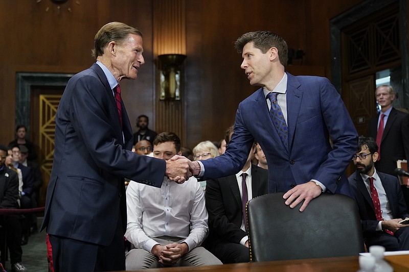 Sen. Richard Blumenthal, D-Conn., left, chair of the Senate Judiciary Subcommittee on Privacy, Technology and the Law, greets OpenAI CEO Sam Altman before a hearing on artificial intelligence, Tuesday, May 16, 2023, on Capitol Hill in Washington. (AP Photo/Patrick Semansky)