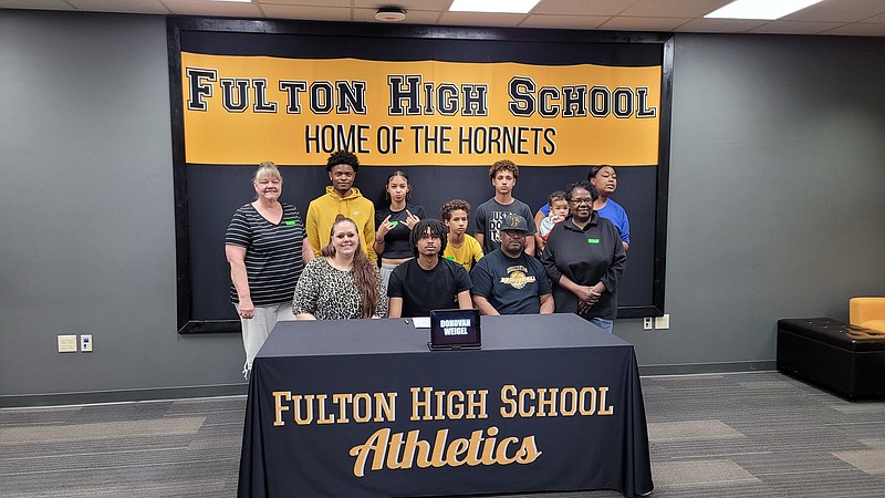 Fulton's Donovan Weigel poses for a photo with his family as he officially signs to play basketball for William Woods University Tuesday at Fulton High School in Fulton. (Courtesy/Fulton Acitivites)