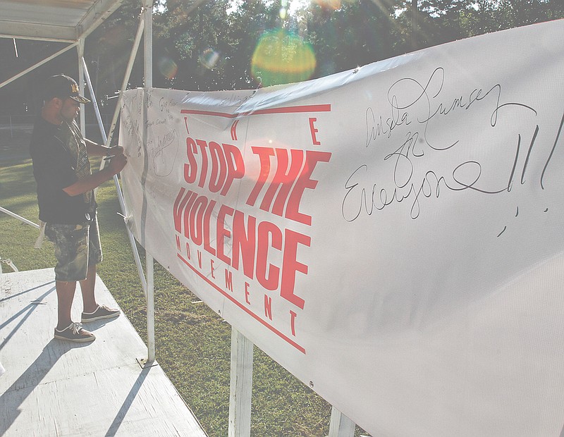 André Corley writes down the name of his brother Billy Edwards Jr. on a banner honoring loved ones during the Stop the Violence: A Celebration of Lost Loved Ones event at Mattocks Park in this 2017 News-Times file photo. A new group with a similar mission to Stop the Violence has been formed to address recent teen violence in El Dorado.